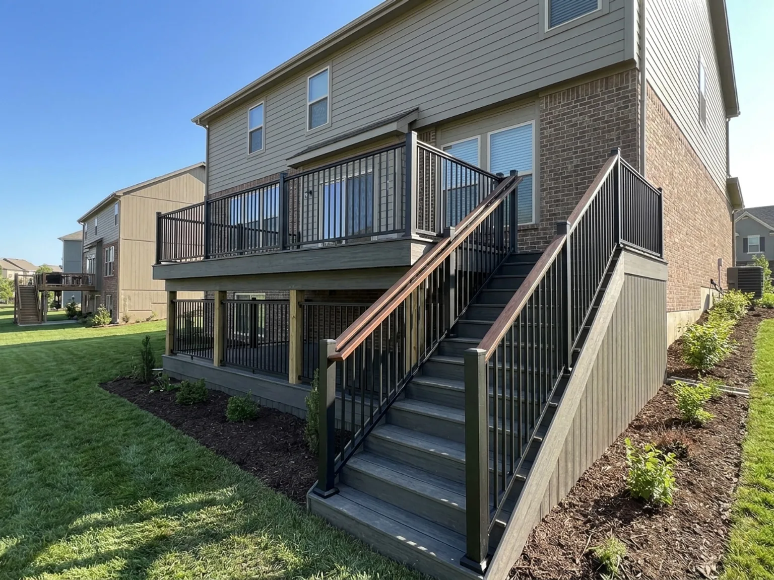 New deck with a code-compliant railing and tightly spaced balusters on a Kansas City home