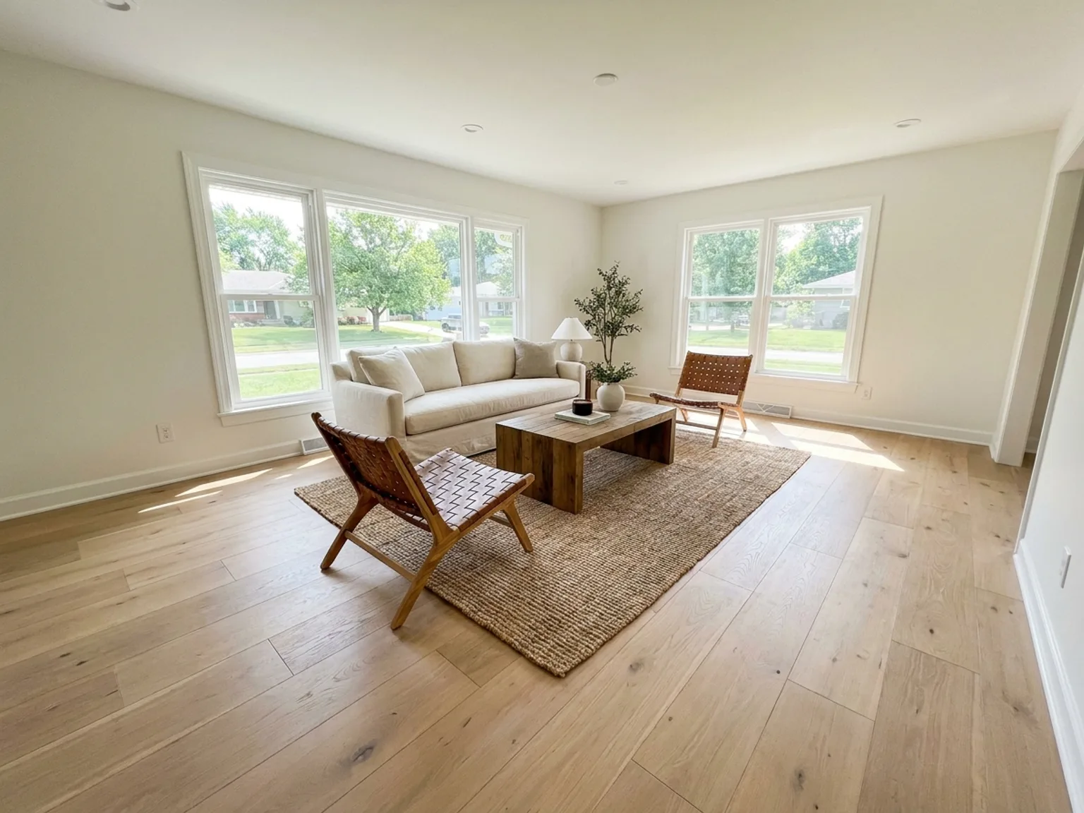 Living room with newly installed white oak hardwood flooring in a Kansas City home