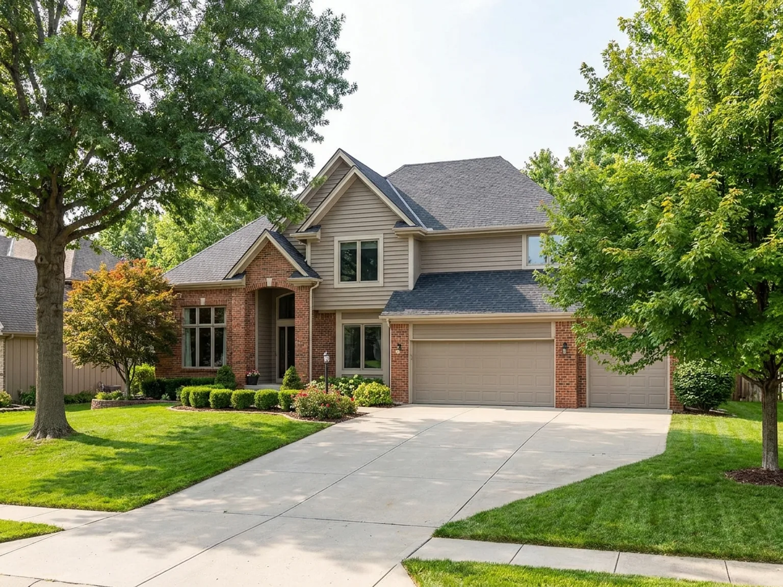 Attractive two-story suburban home with a manicured lawn in the Kansas City metro