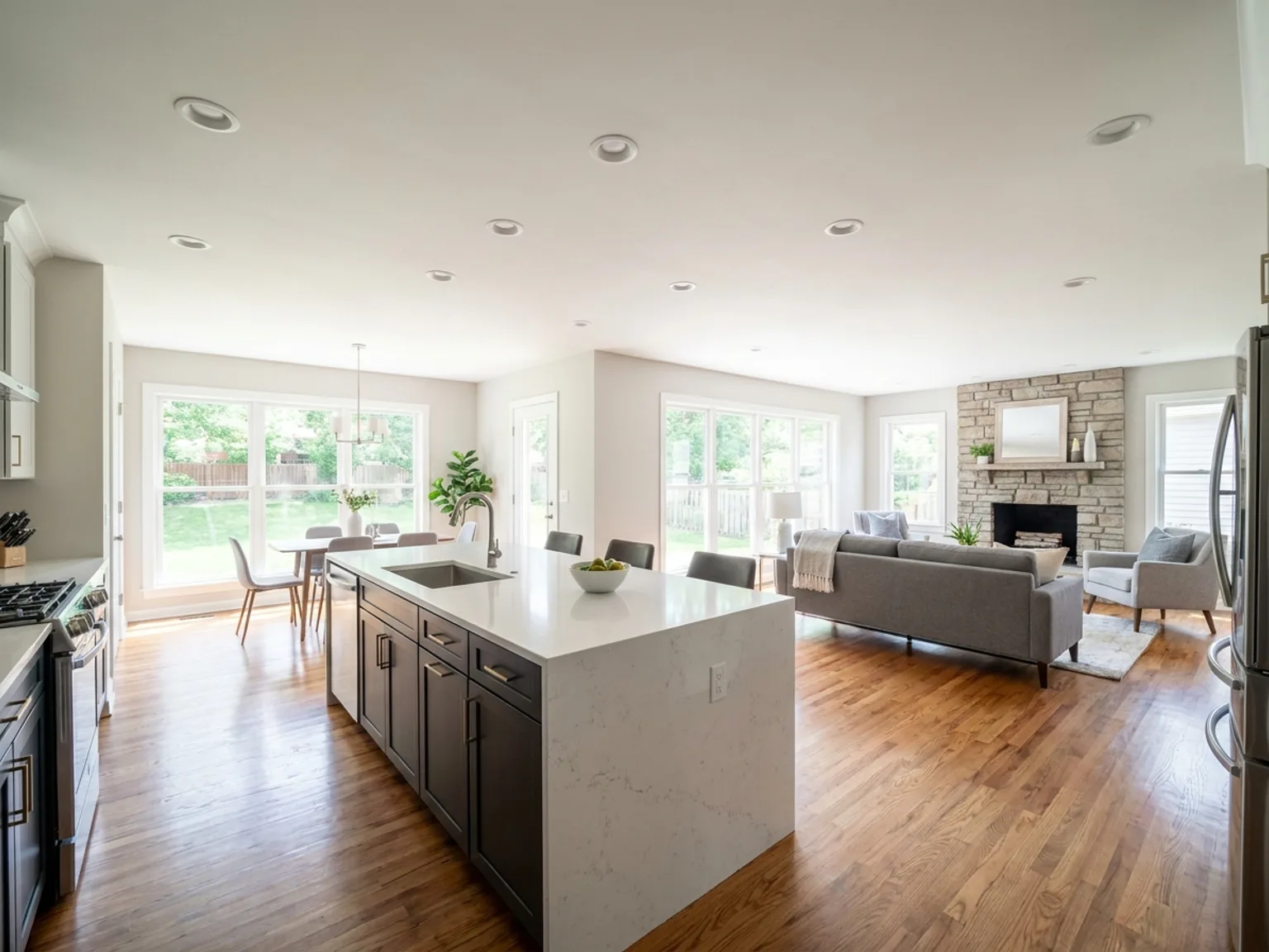 Open-concept kitchen and living area with a flush ceiling beam after load-bearing wall removal in a Kansas City home