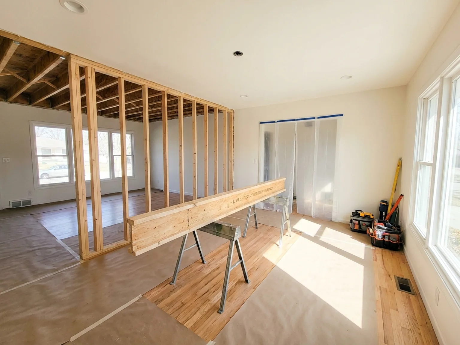 Temporary shoring wall supporting the ceiling during load-bearing wall removal in a Kansas City home