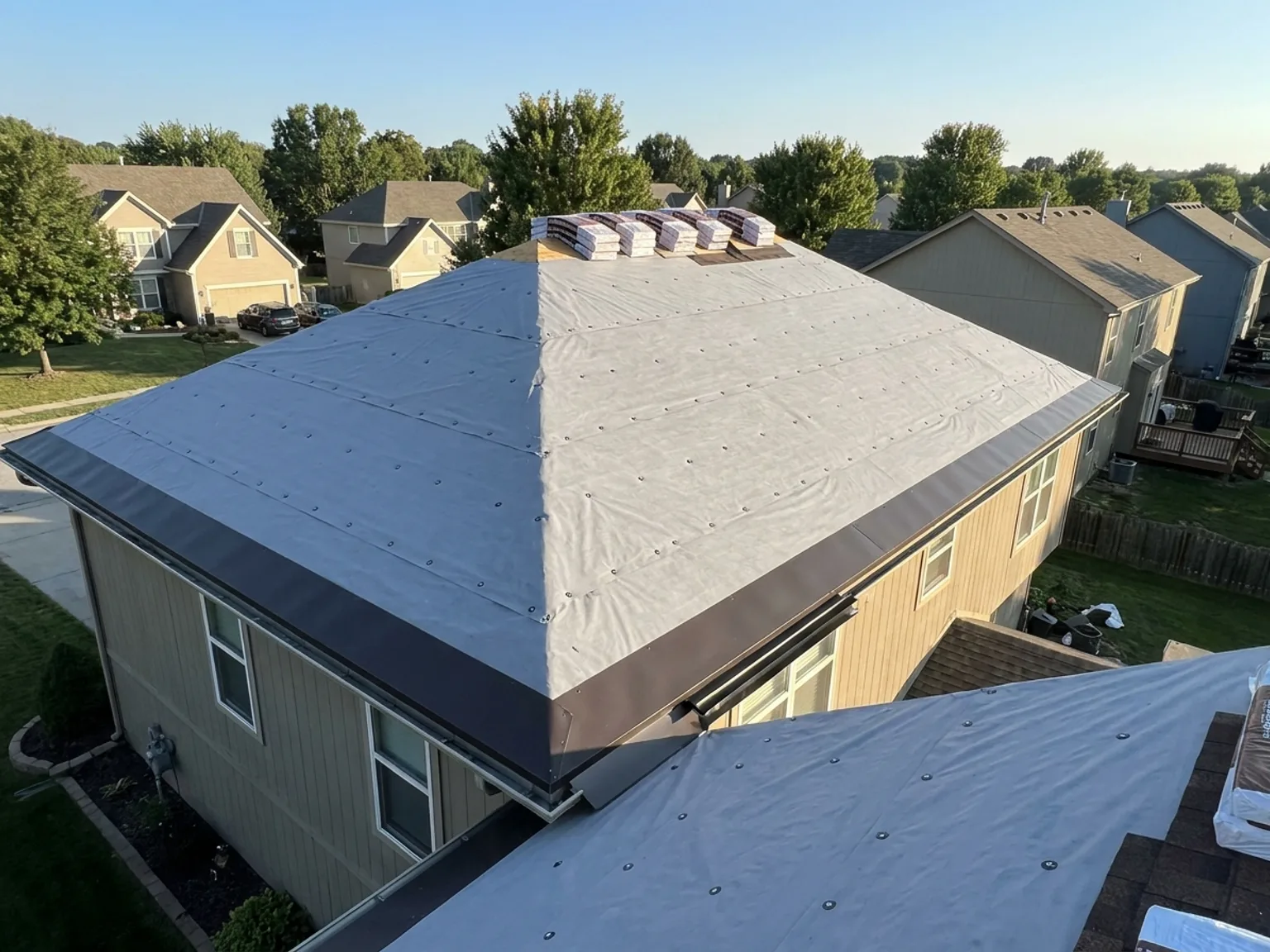 Roof deck covered in fresh synthetic underlayment during a Kansas City roof replacement
